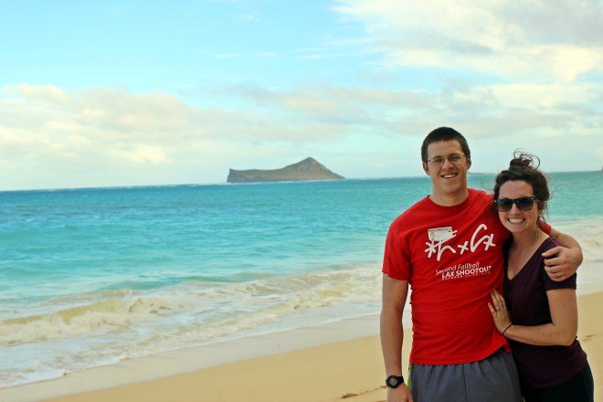 Cody and Kasey in front of the baby blue water of Kailua Beach