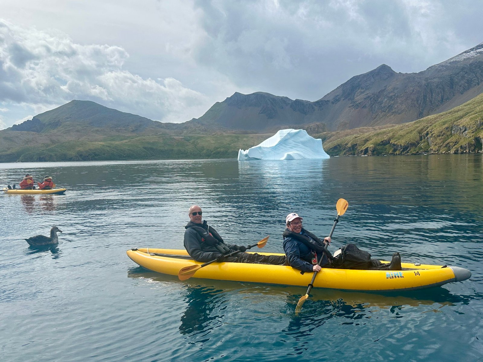 Us in the Kayak in front of a large iceberg in the bay.