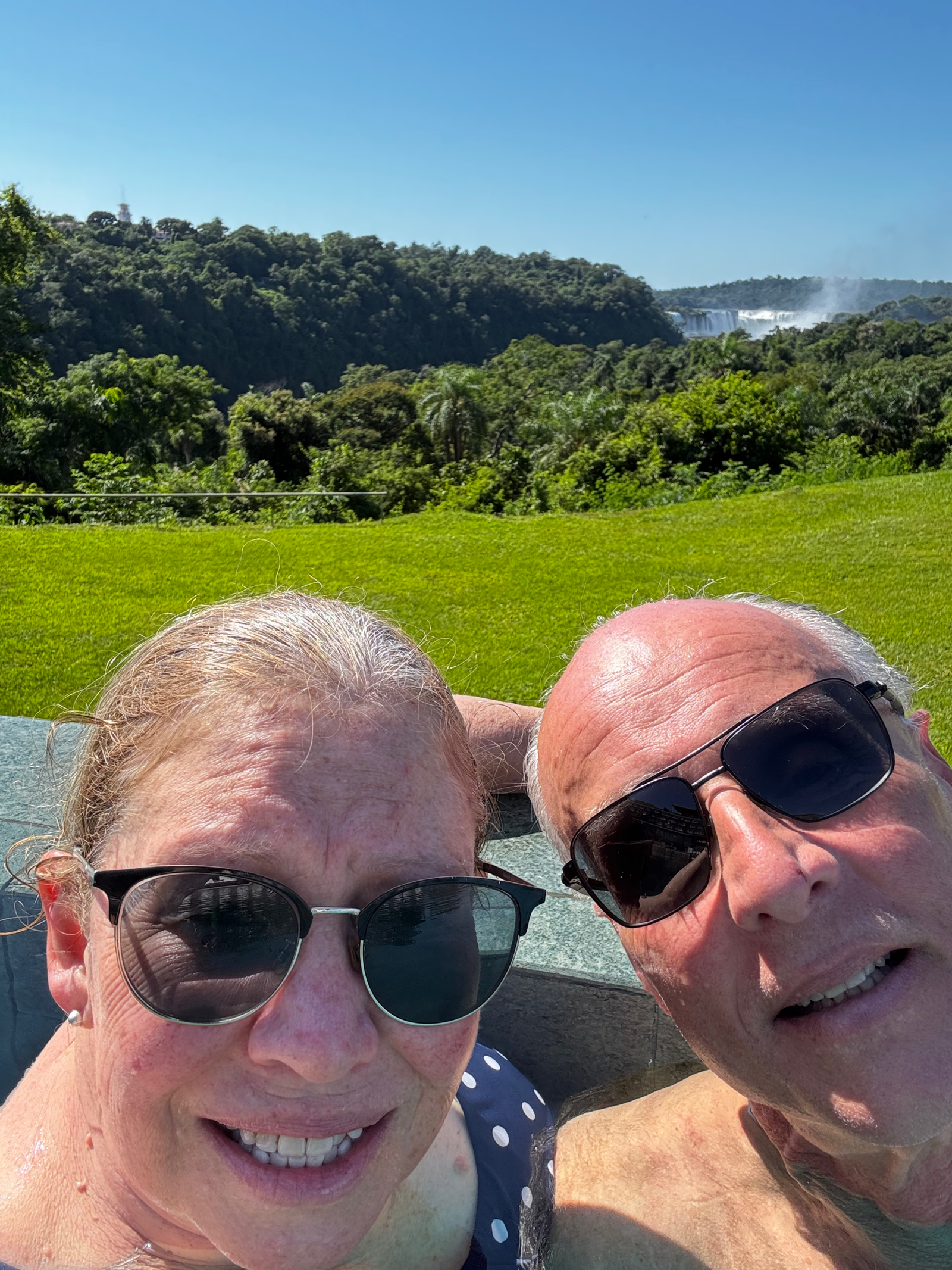 Us in the Infinity pool with the falls in the background